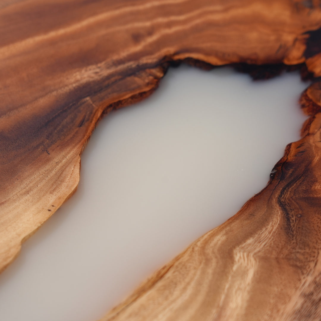 Artisan-made round walnut resin table in modern living room setting