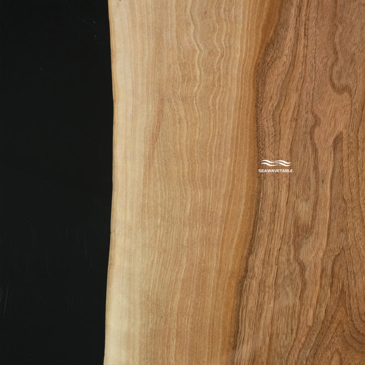 Macro detail of resin black walnut coffee table showing polished wooden coffee table top and artistic epoxy finish - SeaWaveTable