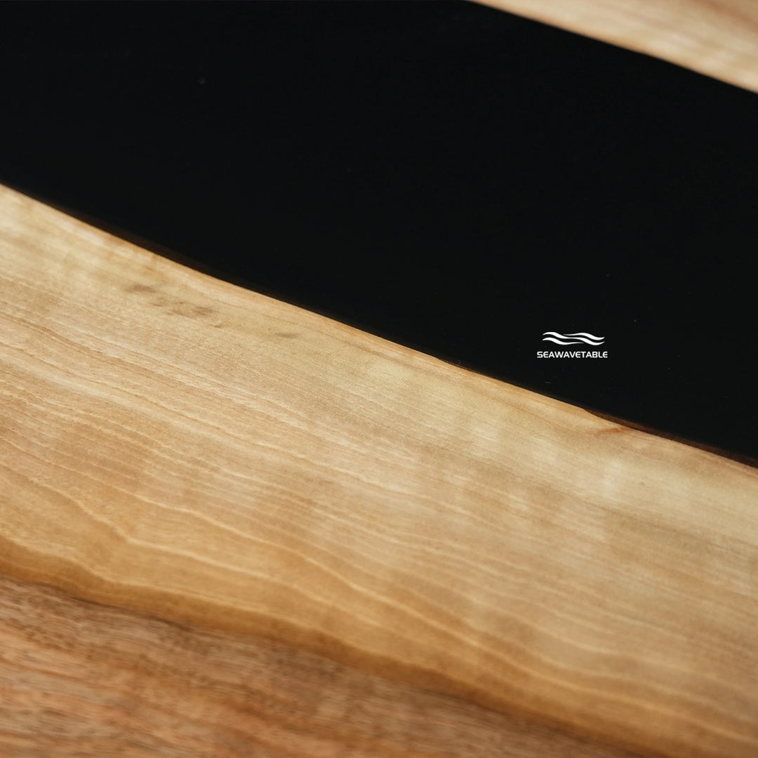 Close-up of resin black walnut coffee table top showing natural wood grain and black epoxy resin details - SeaWaveTable