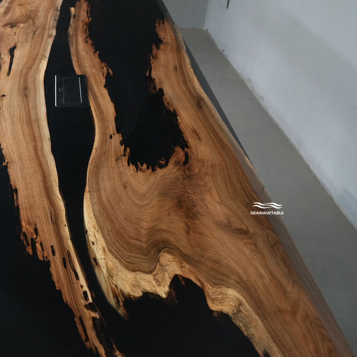 Power outlet detail integrated into a black walnut table with epoxy top, designed for modern conference spaces and efficient work - SeaWaveTable