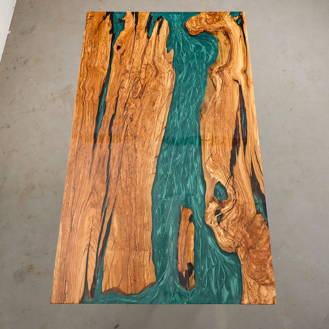 Mystic lagoon epoxy river flowing through solid olive wood table