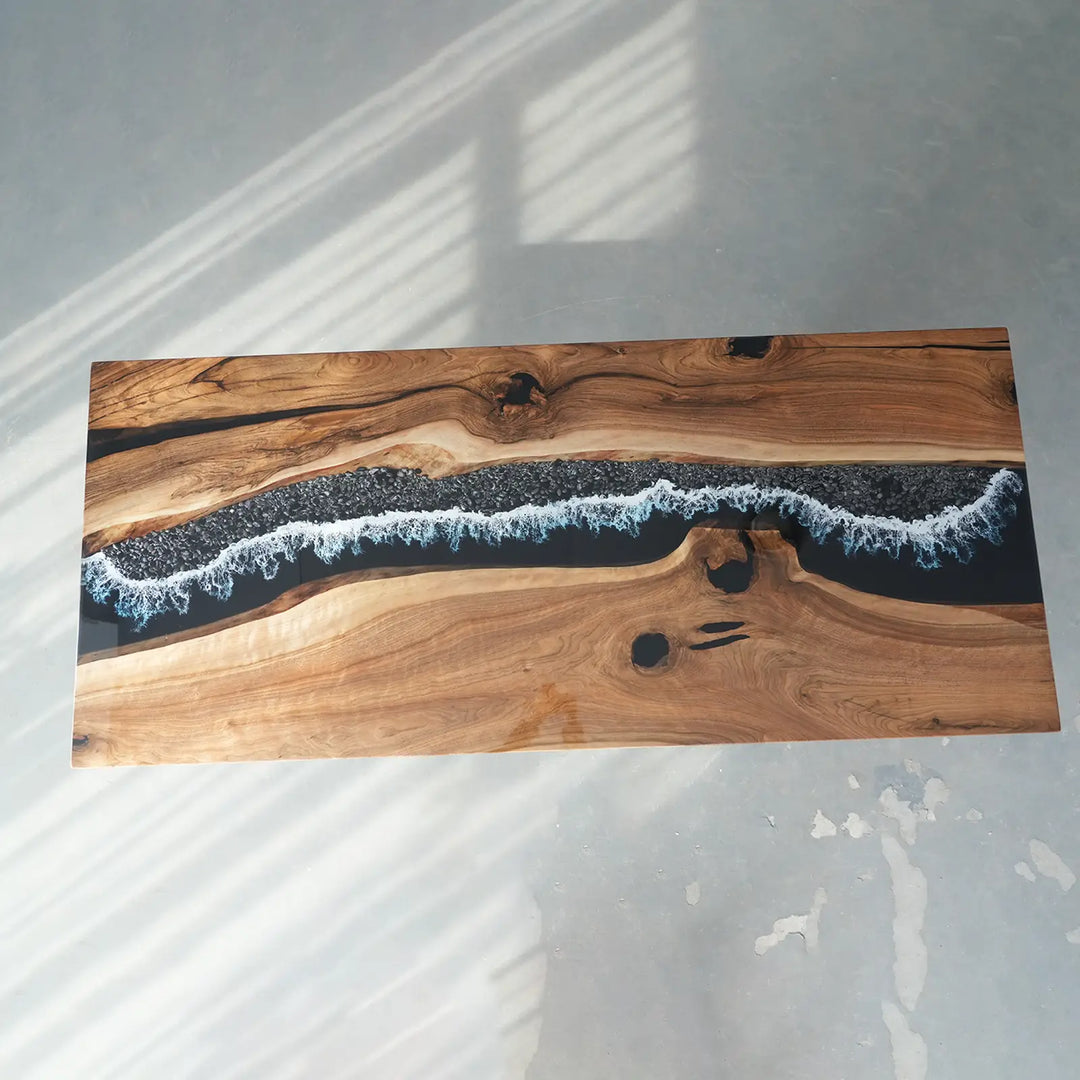 Natural wood slab tabletop with artistic black epoxy resin river