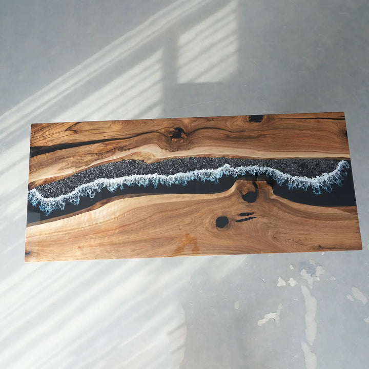 Natural wood slab tabletop with artistic black epoxy resin river