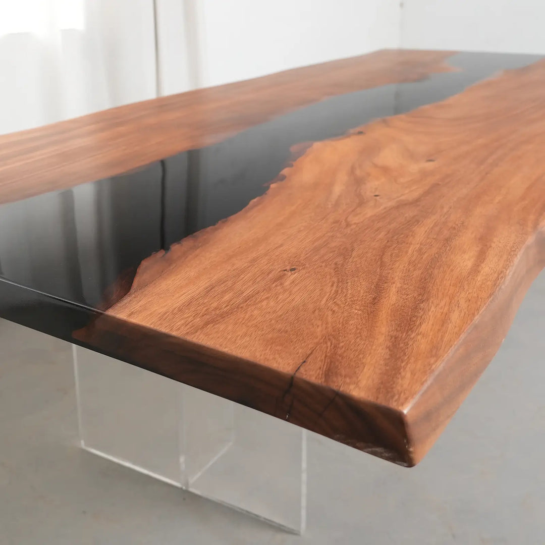 Custom walnut wood dining table with a flowing black resin center