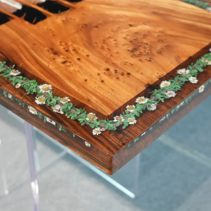 Custom epoxy resin furniture with a colorful centerpiece and botanical accents