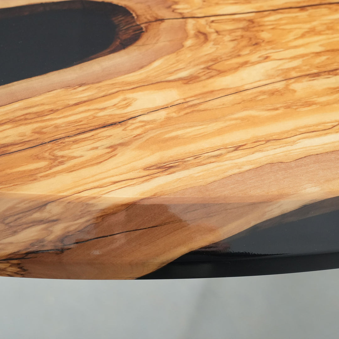 Unique olive wood slab table with glossy black epoxy finish