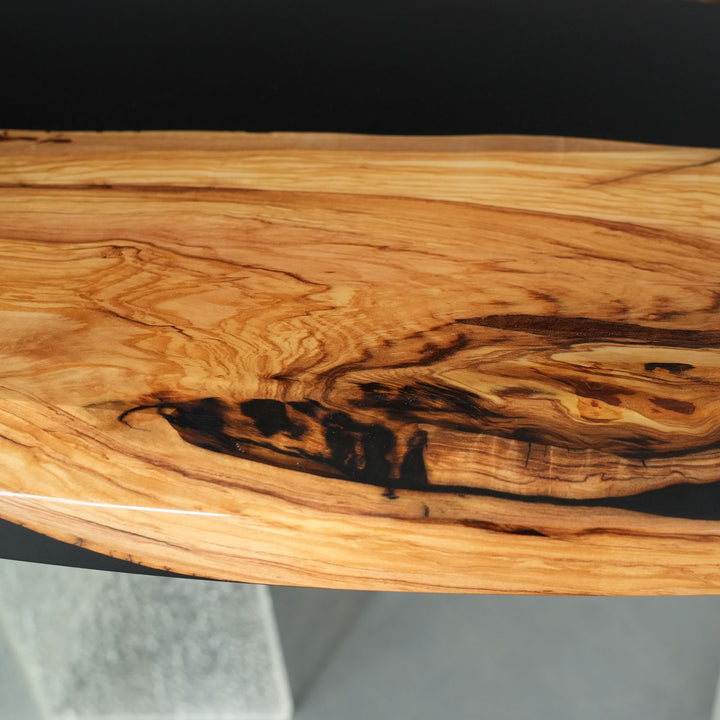 Artisan olive wood dining table with sculptural black resin design