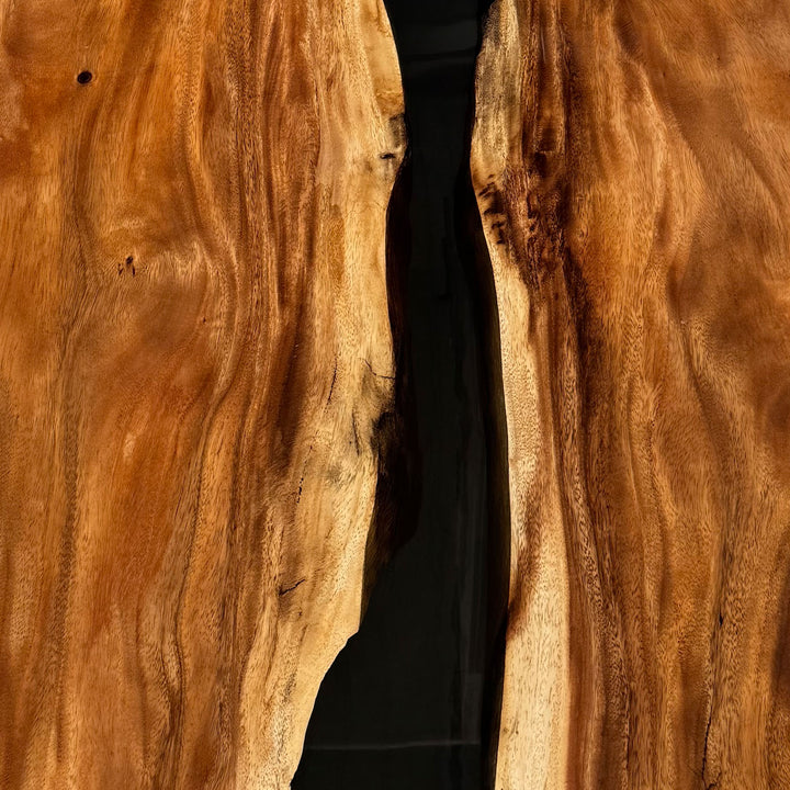 Bespoke live edge dining table with artistic black resin flow and industrial legs.