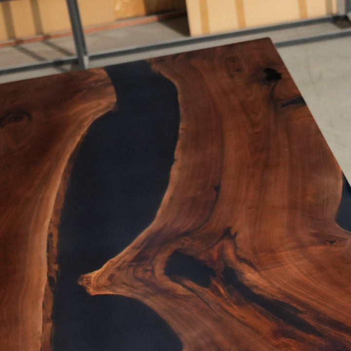 Artisan-made black walnut slab table with black epoxy river pour