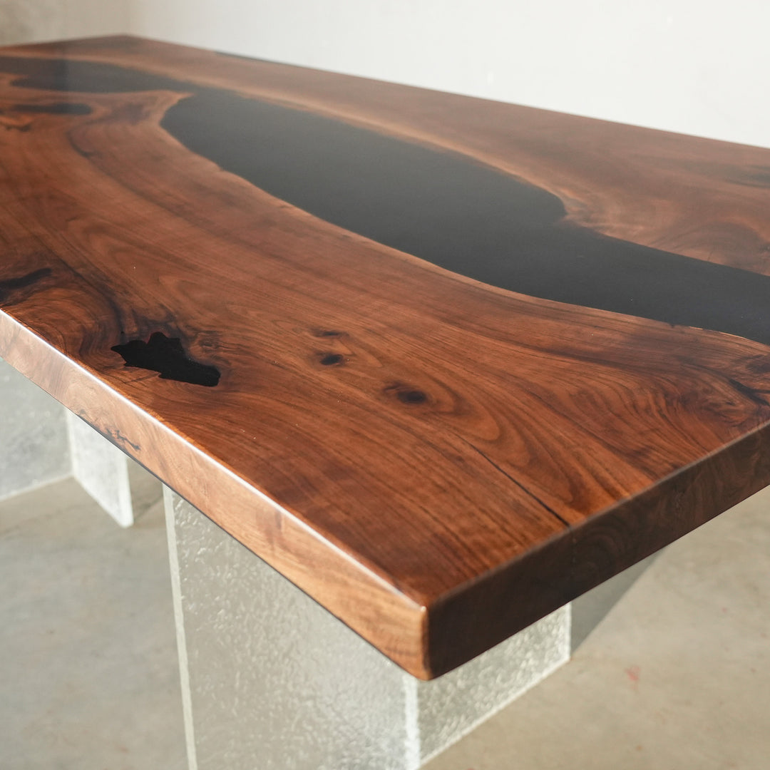 Midnight black resin and black walnut wood dining table in minimalist style