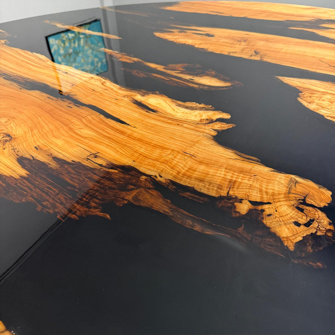 Textured detail of the natural olive wood grain against the smooth, reflective surface of the "Midnight Black" epoxy river.
