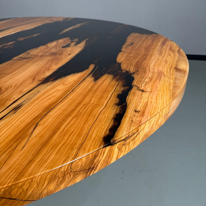 Side view of the Seattle Urban Industrial round table, showcasing the 2-inch thick tabletop and the contrast between wood and resin.