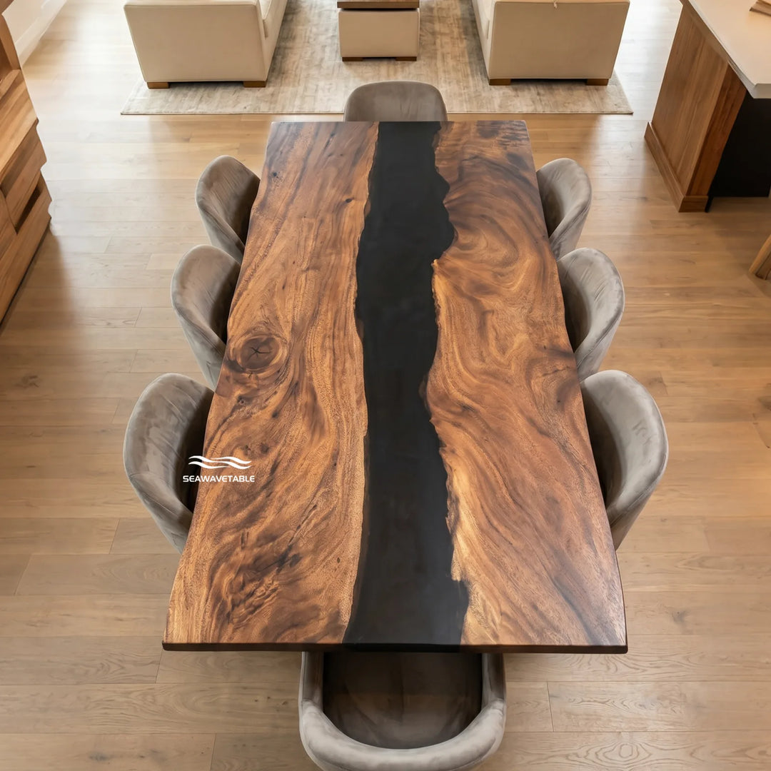 SeawaveTable-A rectangular wooden dining table with a thick live-edge natural wood top and a dark resin channel down the center, surrounded by eight gray upholstered dining chairs in a modern dining room setting.