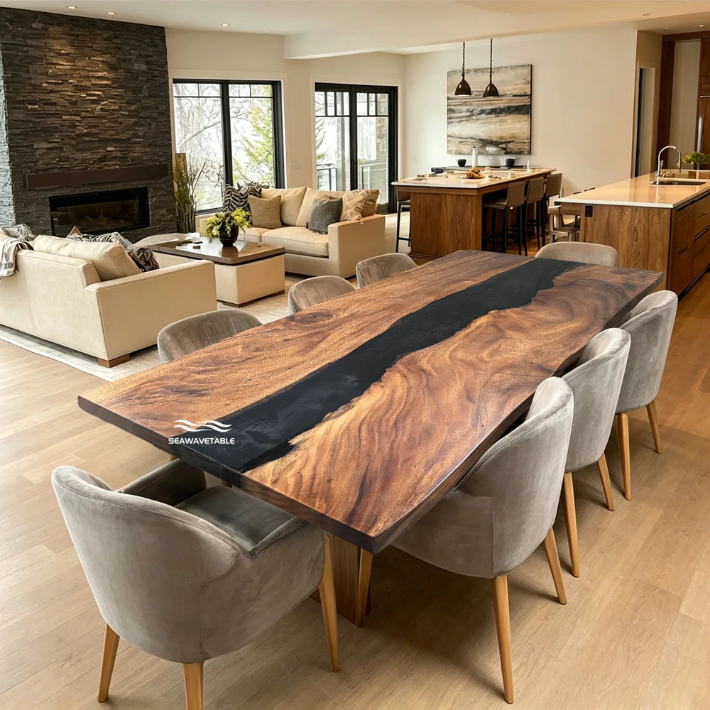 SeawaveTable-A large rectangular live-edge wooden dining table with a dark central resin channel, surrounded by eight gray upholstered dining chairs in a modern open-plan living room and kitchen setting.
