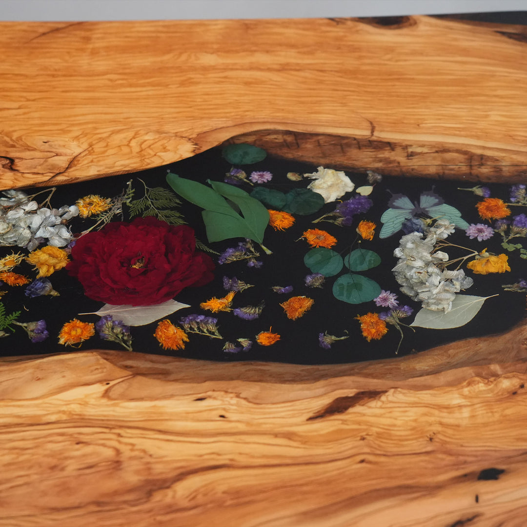 Artistic resin river featuring roses and botanicals in olive wood