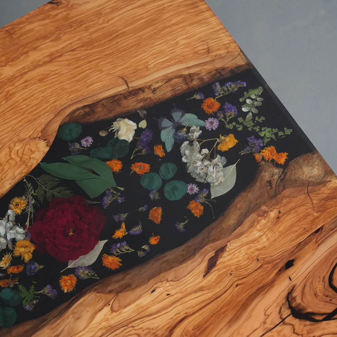 One-of-a-kind olive wood table with botanical resin centerpiece