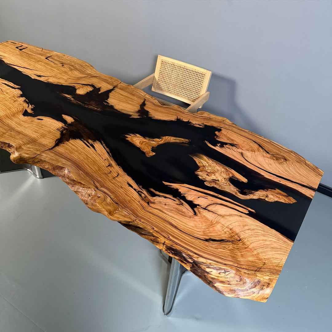 Custom resin wood table showcasing black epoxy and sculpted live edges