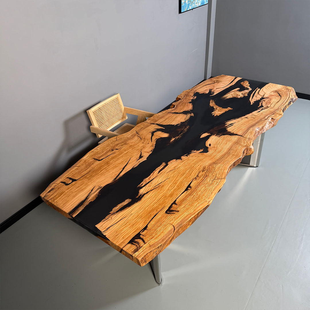 Handmade resin wood table featuring black epoxy and organic live edges