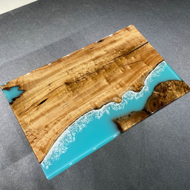 Seawavetable-Custom epoxy table featuring live edge Golden Camphor and swirling blue resin