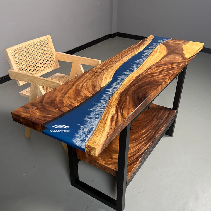 A resin console table display featuring solid walnut wood with a blue resin river and lower shelf, showcased in a bright studio setting for interior design presentation - SeawaveTable