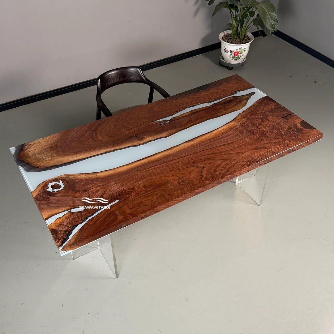 Exhibition view of a custom solid wood dining table with black walnut slab and white resin inlay, displayed in a modern outdoor furniture gallery or design showroom - SeawaveTable