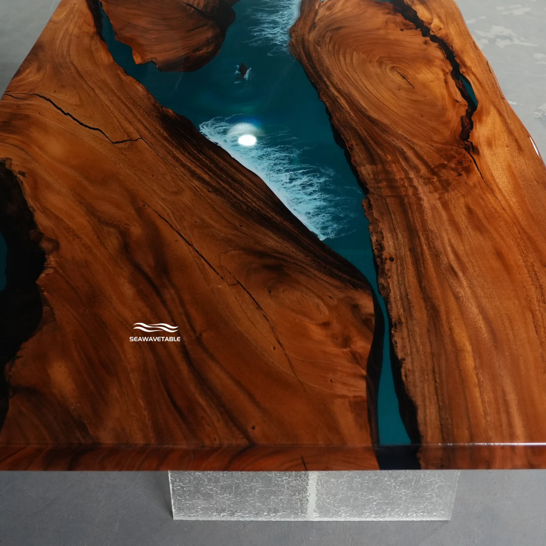 Surface detail of a custom resin table capturing the striking contrast between the warm walnut wood and the brilliant blue glossy resin ocean - SeawaveTable