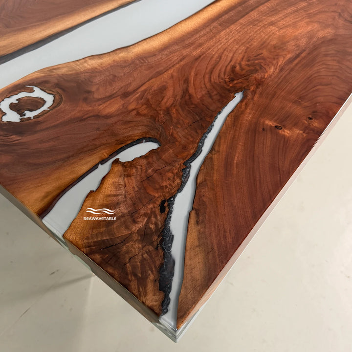 Close-up detail of a resin table showing the flowing white river channel cutting through the rich black walnut grain - SeawaveTable