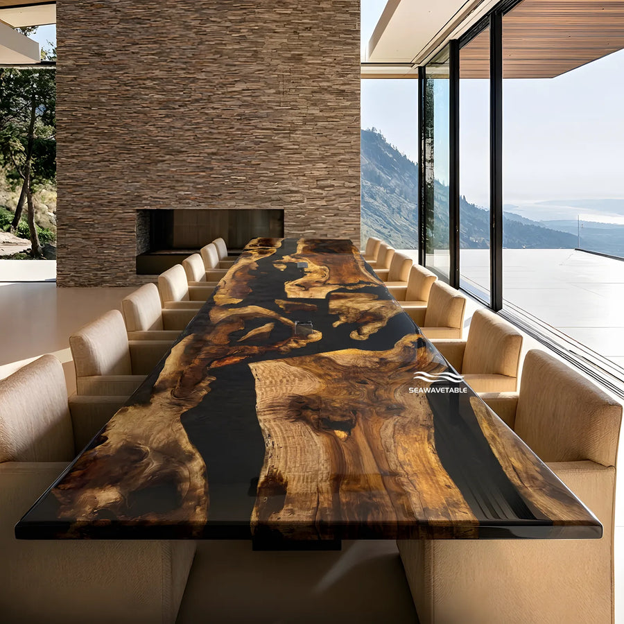 A commanding live-edge wood conference table with a deep, glossy brown finish and natural grain character, surrounded by beige chairs in a sunlit corporate boardroom overlooking majestic mountain scenery.