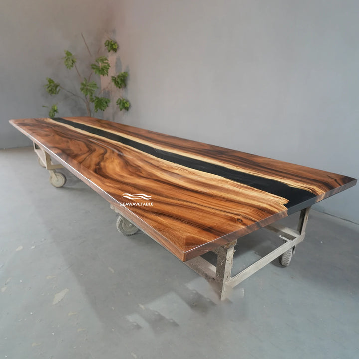 Exhibition view of a custom epoxy table with walnut wood and flowing black resin, displayed in a modern office furniture gallery or design showroom - SeawaveTable
