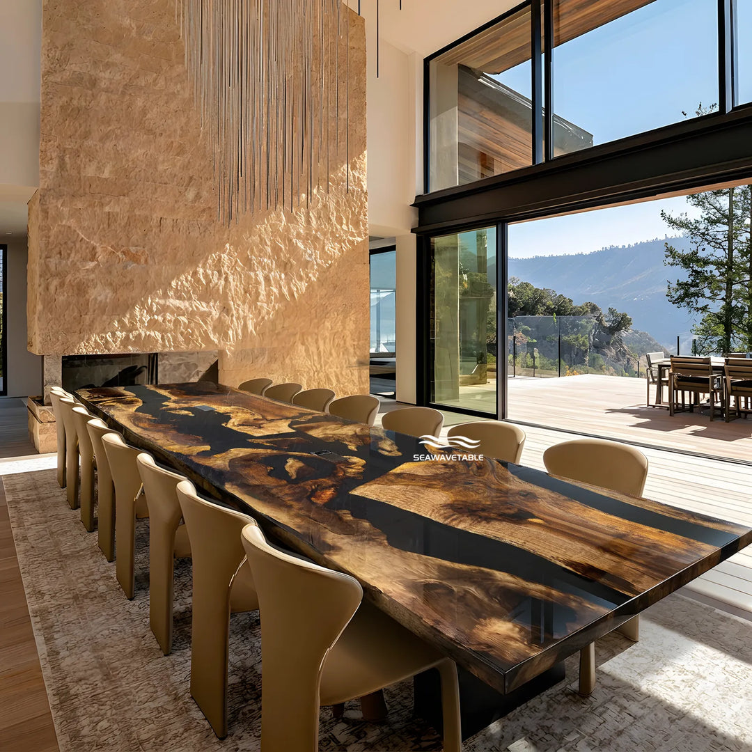 A long live-edge conference  table with a glossy dark wood and resin surface, surrounded by beige chairs in a modern conference  room with large windows and a stone fireplace.