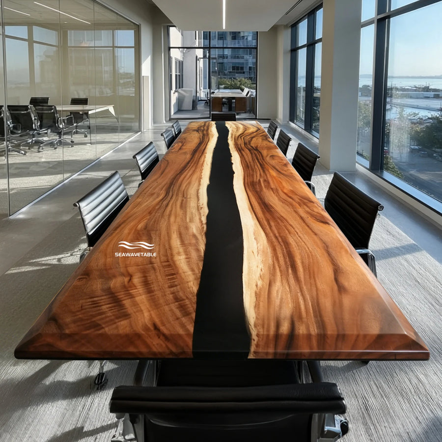 A large beveled-edge walnut epoxy conference table with a dark resin river flowing through the center, surrounded by modern black office chairs in a bright corporate boardroom with floor-to-ceiling windows and natural light - SeawaveTable