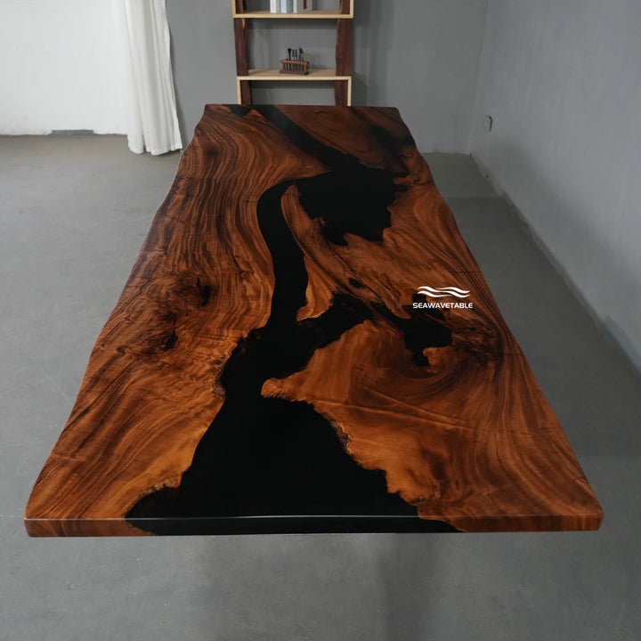 Exhibition view of a custom epoxy table with walnut wood and flowing black resin, displayed in a modern furniture gallery - SeawaveTable