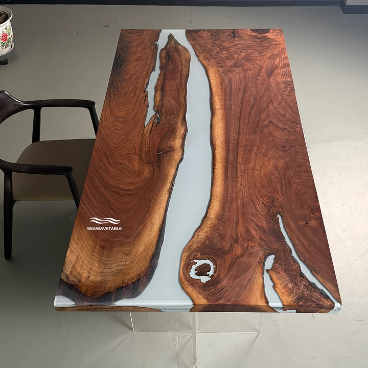 Black walnut epoxy river dining table exhibited in a professional showroom, highlighting the live-edge design, white resin channel, and glossy surface finish - SeawaveTable