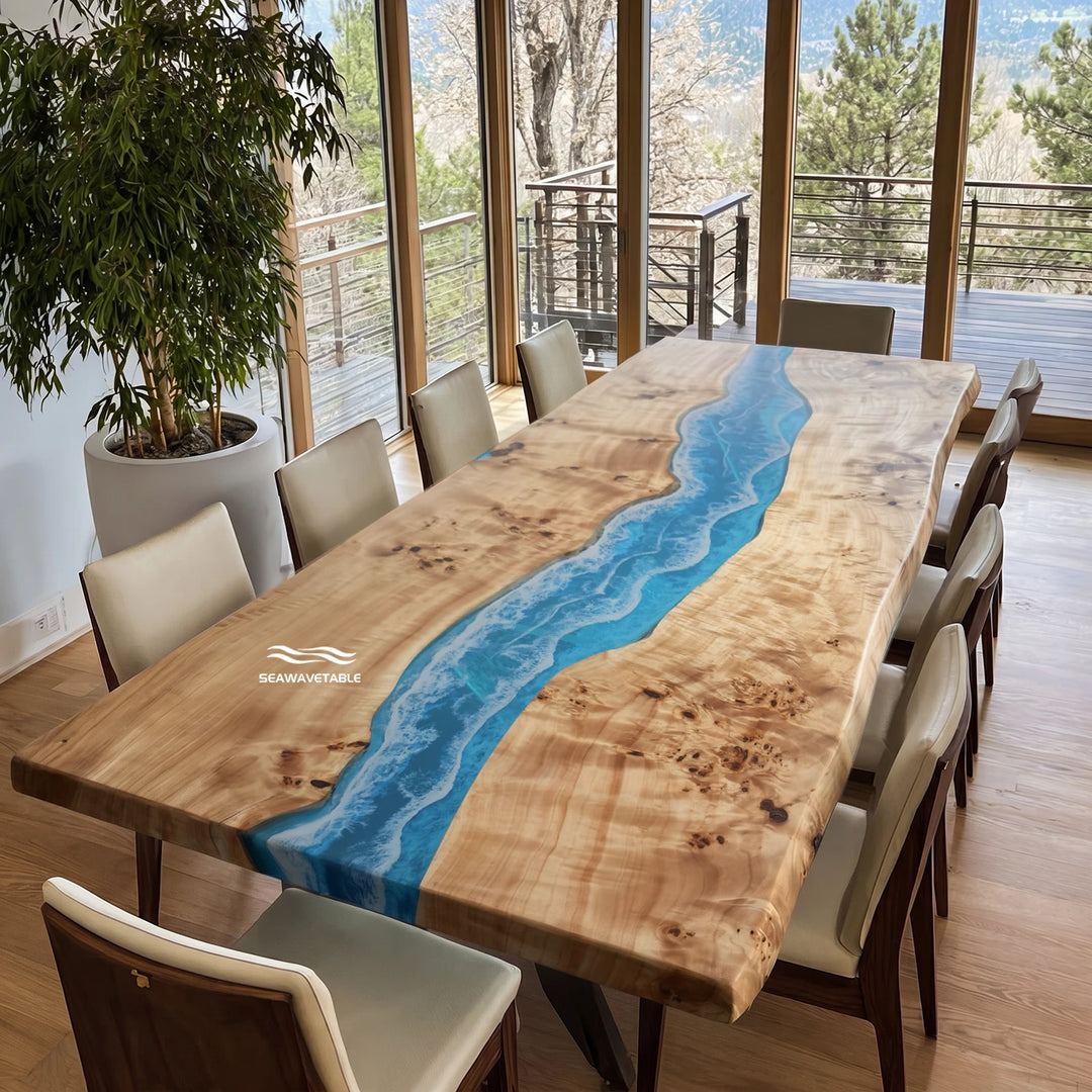 A live-edge poplar epoxy dining table with a vibrant blue resin river flowing through the center, surrounded by modern chairs in a bright contemporary dining room with large windows and natural light - SeawaveTable