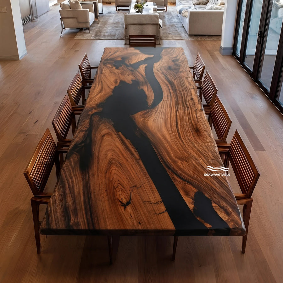 A long live-edge walnut dining table with a dramatic black resin river running through rich brown wood grain, surrounded by matching wooden chairs in a modern open-plan living space with natural light - SeawaveTable
