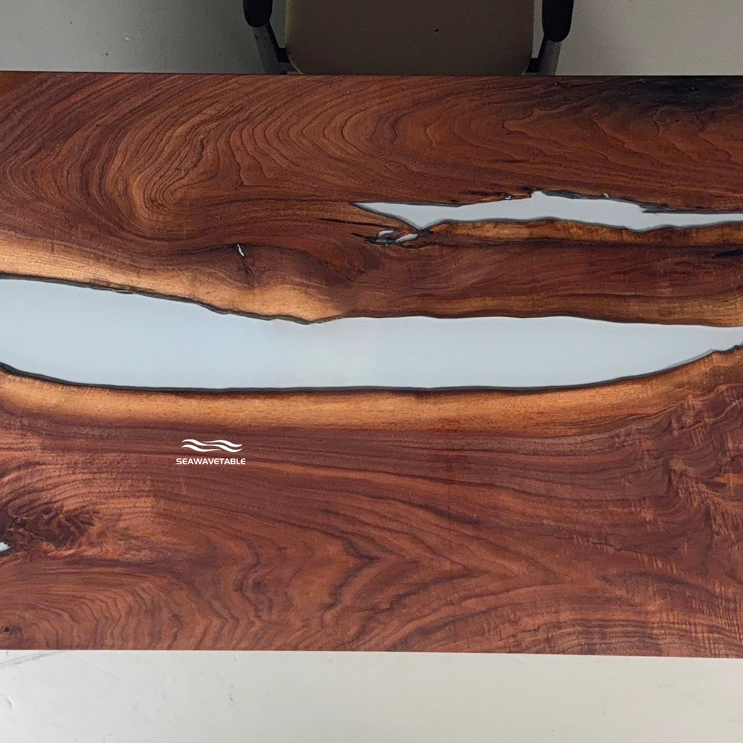 Close-up of a live-edge dining table showing the organic edge contour where the black walnut meets the white resin river - SeawaveTable