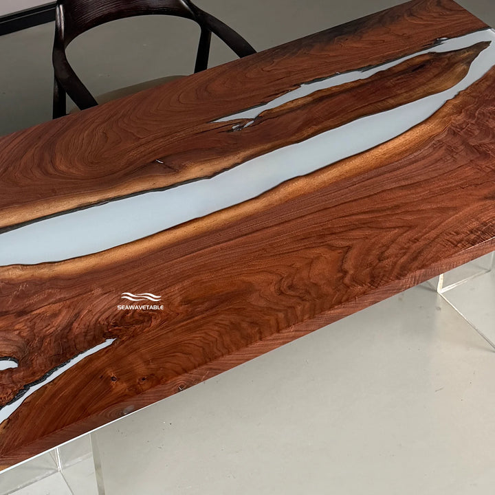 Surface detail of a custom resin dining table capturing the dramatic contrast between the dark walnut wood and the bright white resin river - SeawaveTable