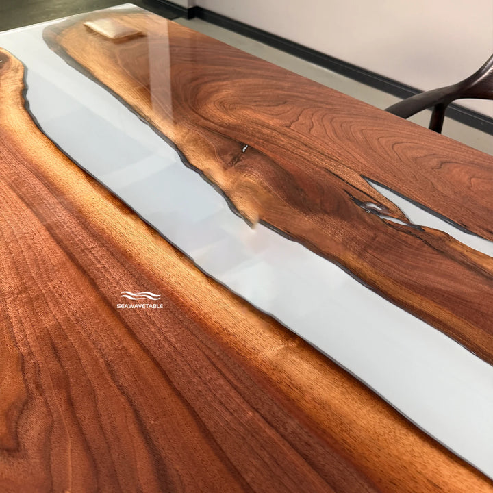 Detail of a solid wood dining table highlighting the natural black walnut grain texture and the smooth glossy resin finish - SeawaveTable