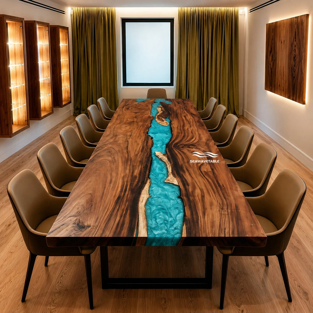 A long wooden dining table with a vivid turquoise river design running down the center, surrounded by brown upholstered chairs in a modern conference or dining room. The table has a visible 'DRAWSTABLE' logo on the right side.