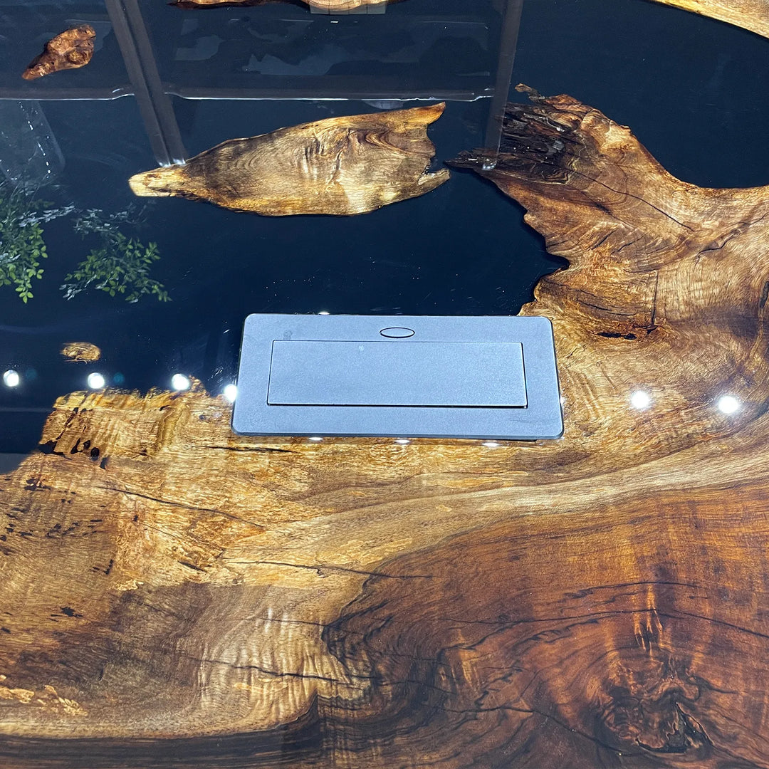Live-edge wooden conference table with glossy brown grain, integrated power outlets, beige upholstered chairs, modern boardroom