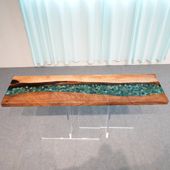 Seawavetable-stones suspended inside clear blue epoxy river of black walnut console table