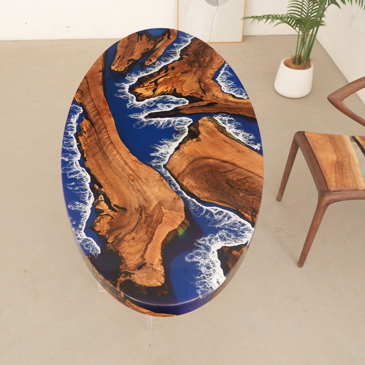 Seawavetable
Artisan round-edge river table with swirling ocean resin and walnut wood accents in a holiday-decorated interior.