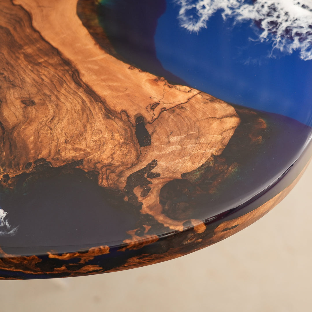 Seawavetable
Custom handmade resin and wood dining table with ocean theme, paired with six black leather chairs and pendant lighting.