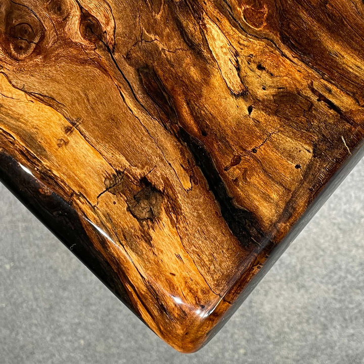 Modern dining table with semi-transparent black epoxy details