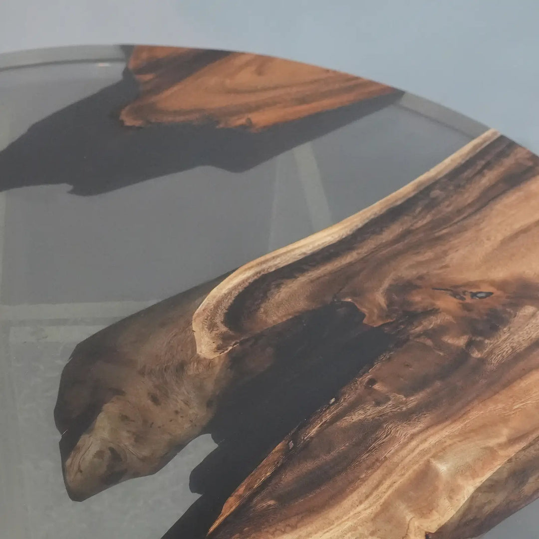 Seawavetable - Closeup view round walnut semi-transparent black resin river table