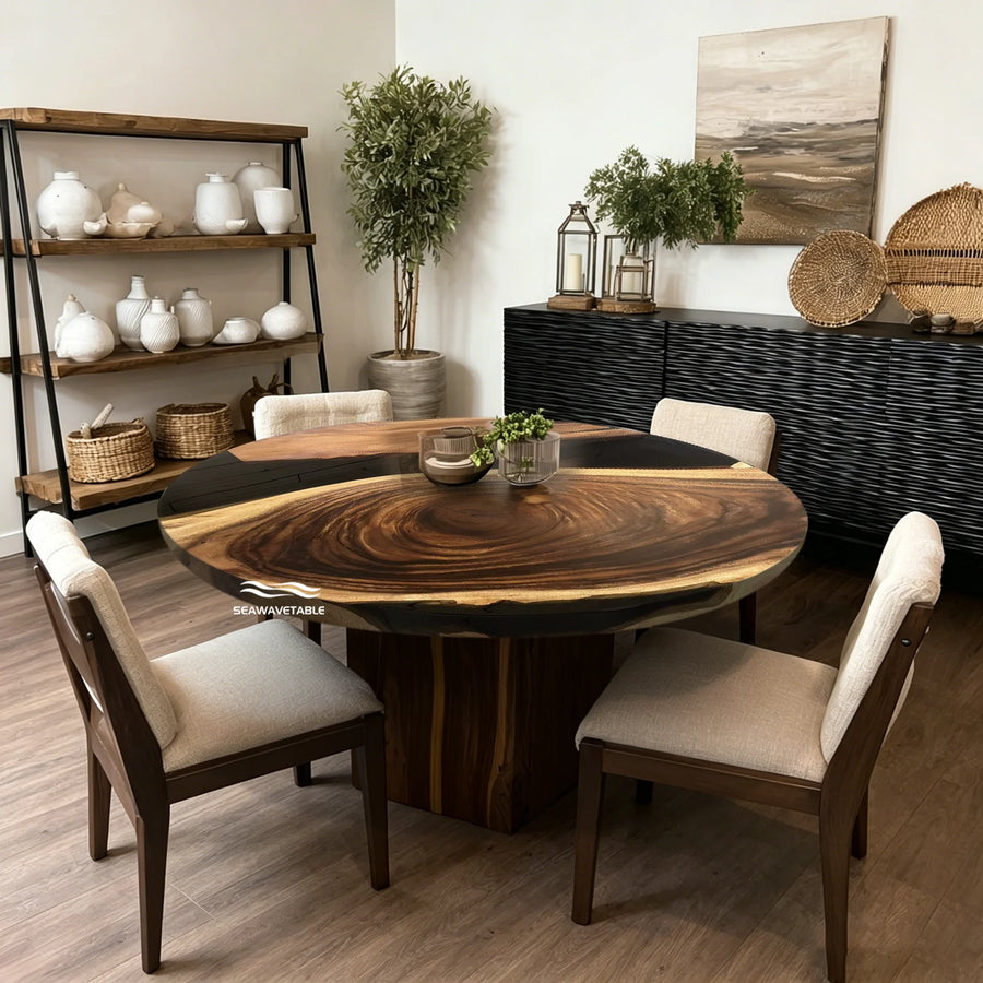 Seawavetable- wooden dining table with a dark wood pedestal base, surrounded by four upholstered wooden chairs in a styled room setting.