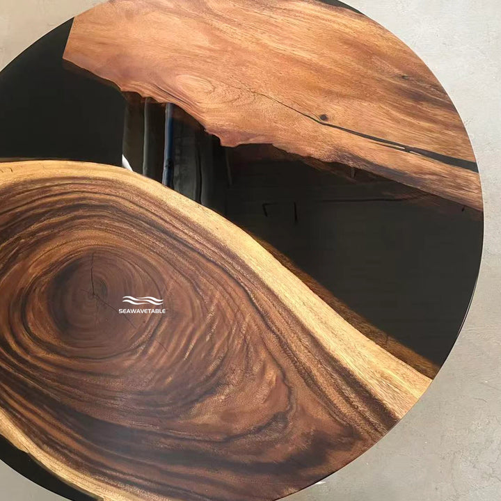 Seawavetable-A round live-edge wooden table with a rich natural wood grain pattern, featuring a prominent swirling grain in the center and a polished finish. 