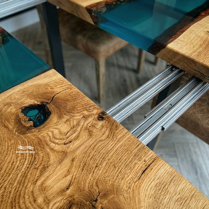 Seawavetable‑Close‑up detail black walnut epoxy table, natural dark wood grain meeting high‑gloss transparent blue epoxy resin river