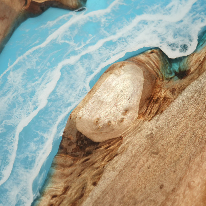 Blue epoxy river table showing wood grain and smooth polish