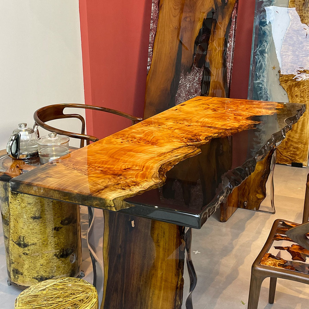Striking live - edge resin table with fir wood, accompanied by a side tea - setup